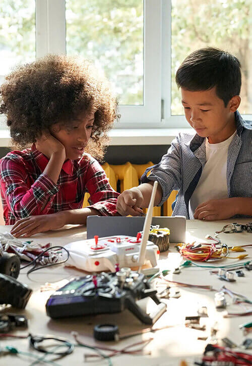 group of multiracial schoolkids in classroom stem education concept